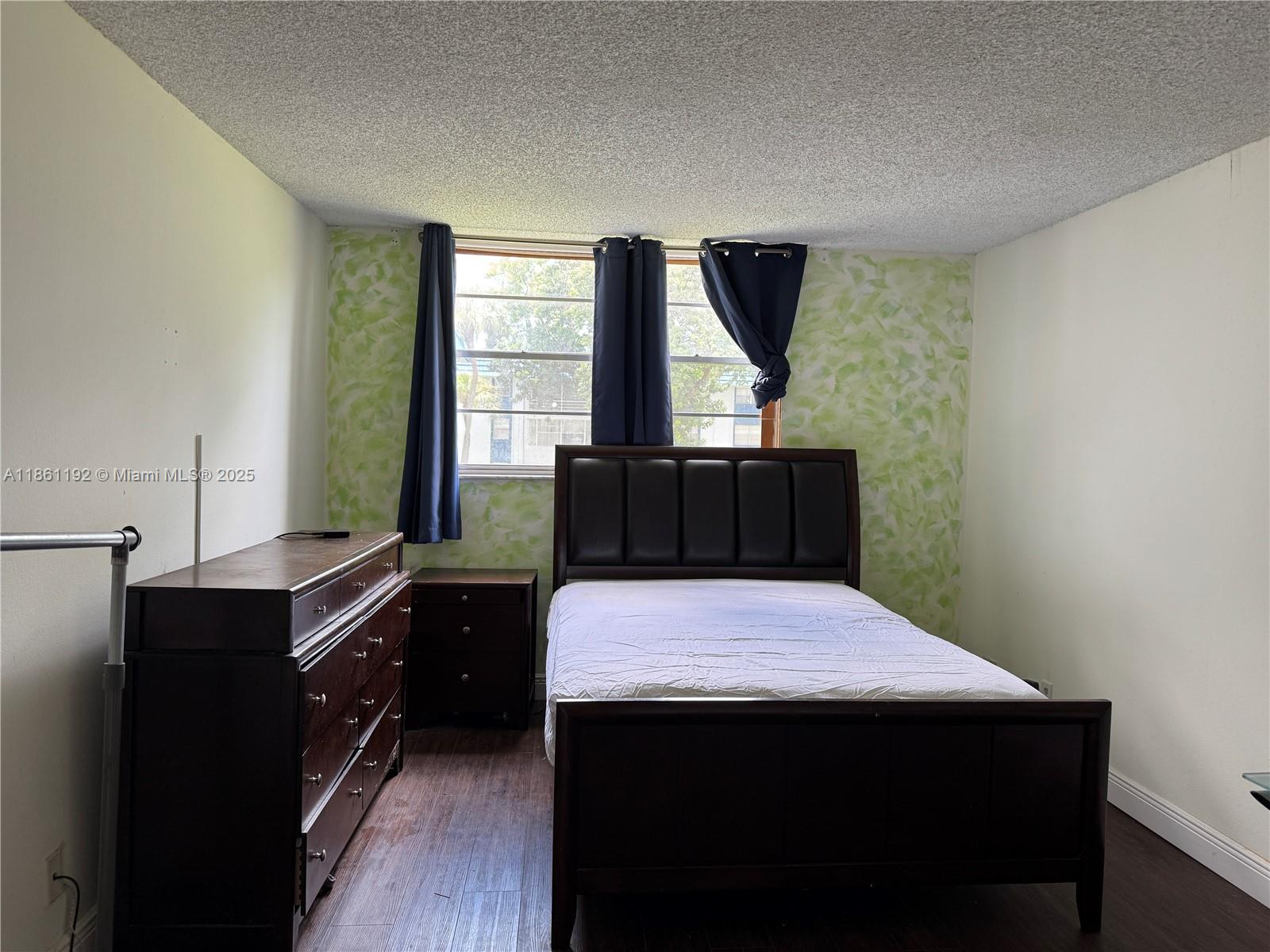 3090 Holiday Springs Boulevard, Unit 206 Margate, FL 33063 - Photo 26 of 41 a bedroom with a bed and a dresser