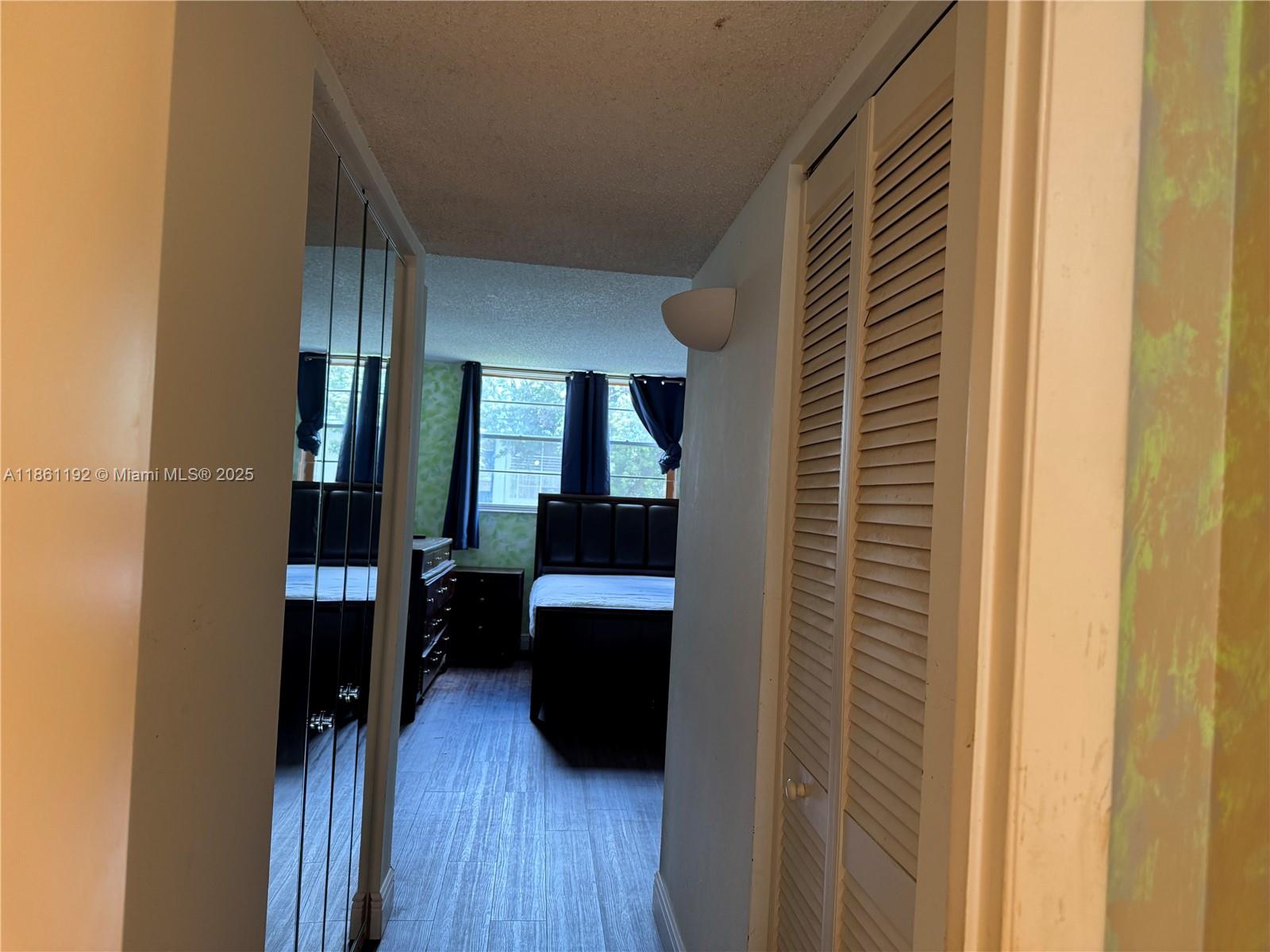 3090 Holiday Springs Boulevard, Unit 206 Margate, FL 33063 - Photo 27 of 41 a view of a hallway with wooden floor and staircase