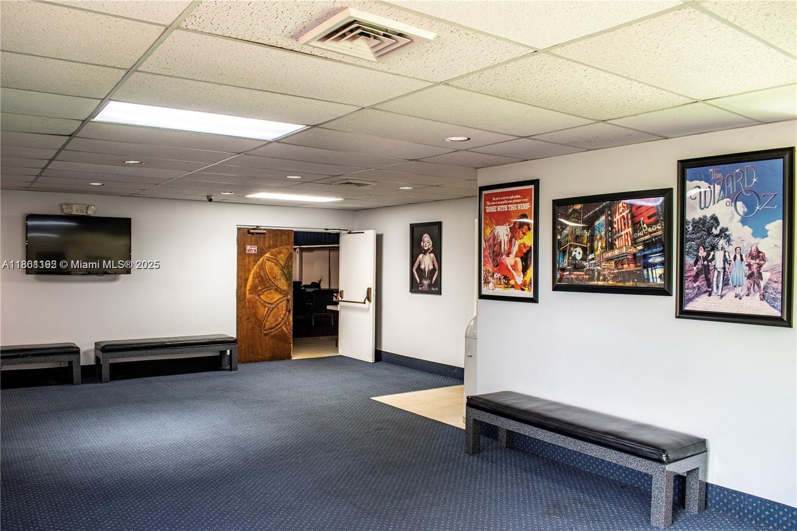 3090 Holiday Springs Boulevard, Unit 206 Margate, FL 33063 - Photo 3 of 41 a living room with furniture gym equipment and a flat screen tv