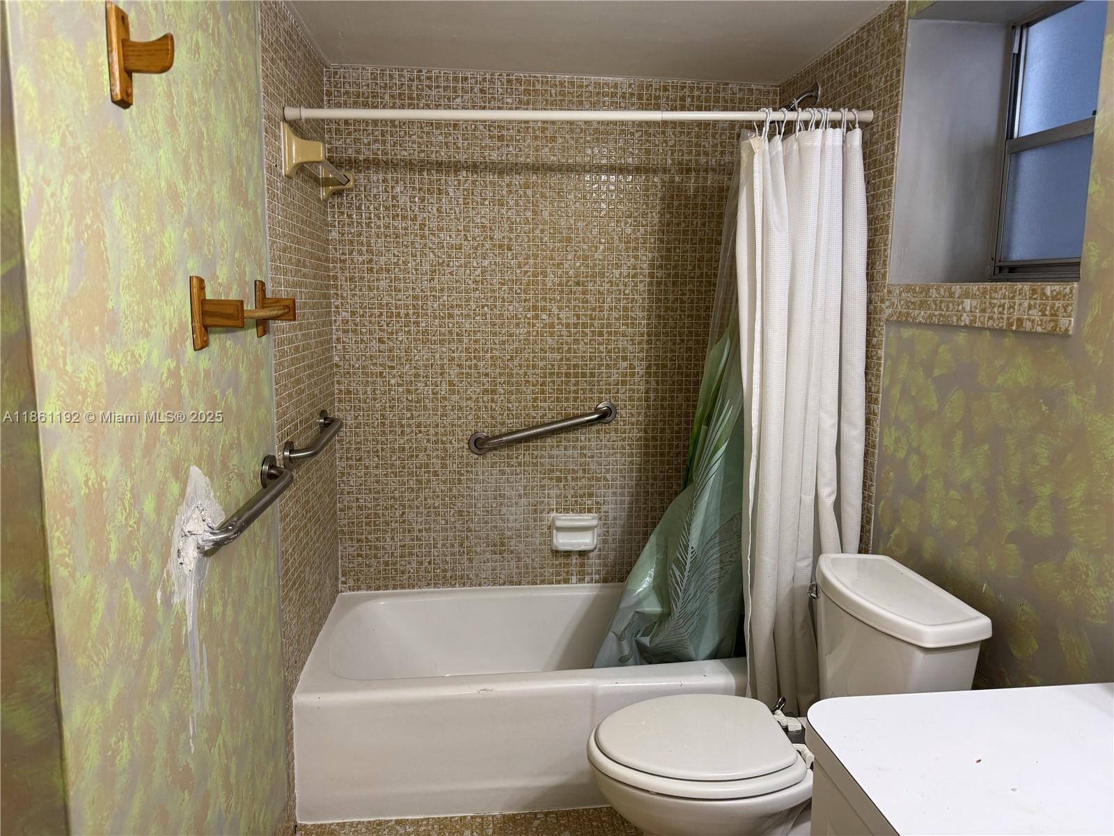 3090 Holiday Springs Boulevard, Unit 206 Margate, FL 33063 - Photo 31 of 41 a white toilet sitting next to a bath tub