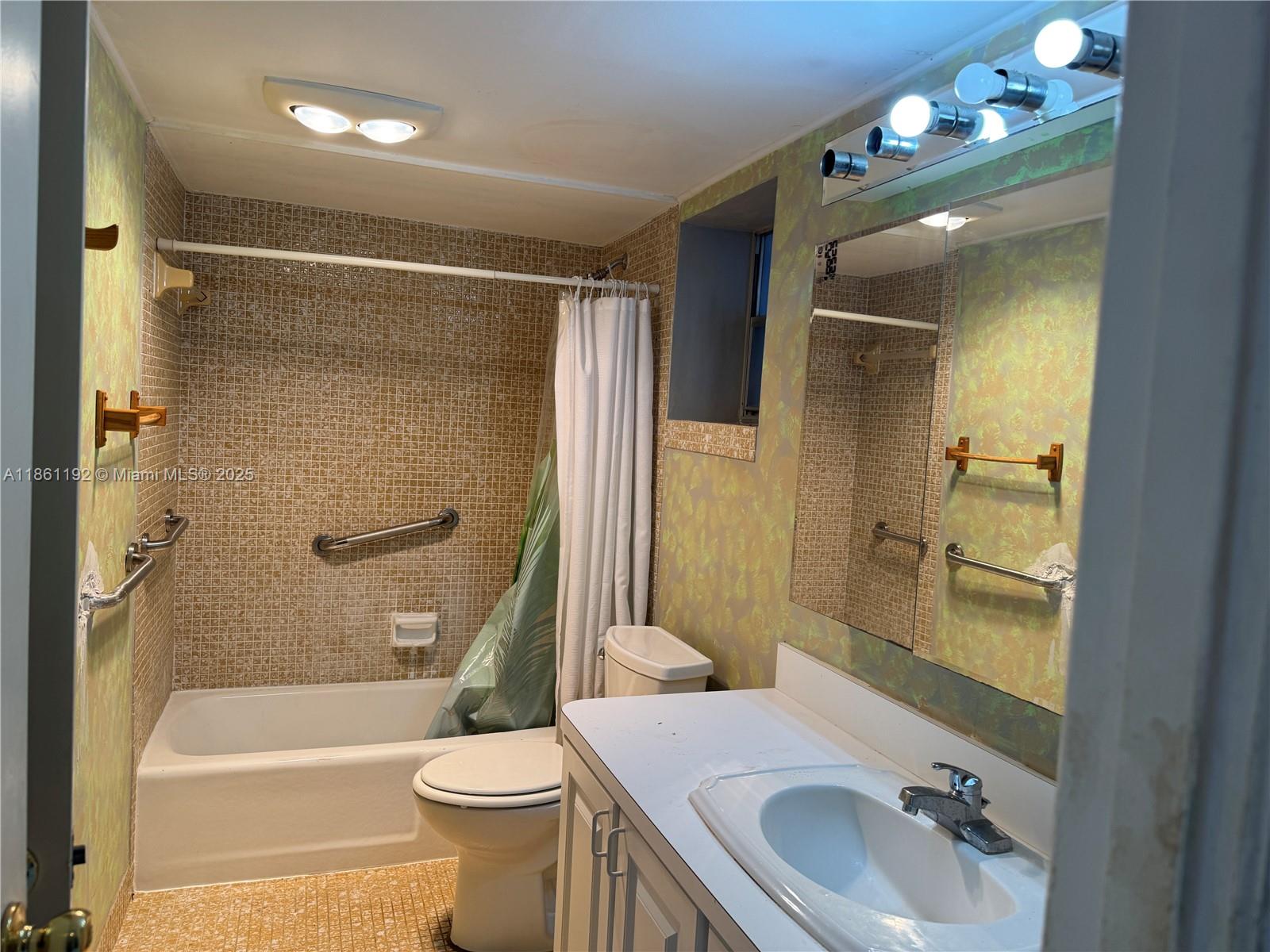 3090 Holiday Springs Boulevard, Unit 206 Margate, FL 33063 - Photo 32 of 41 a bathroom with a sink a toilet and shower