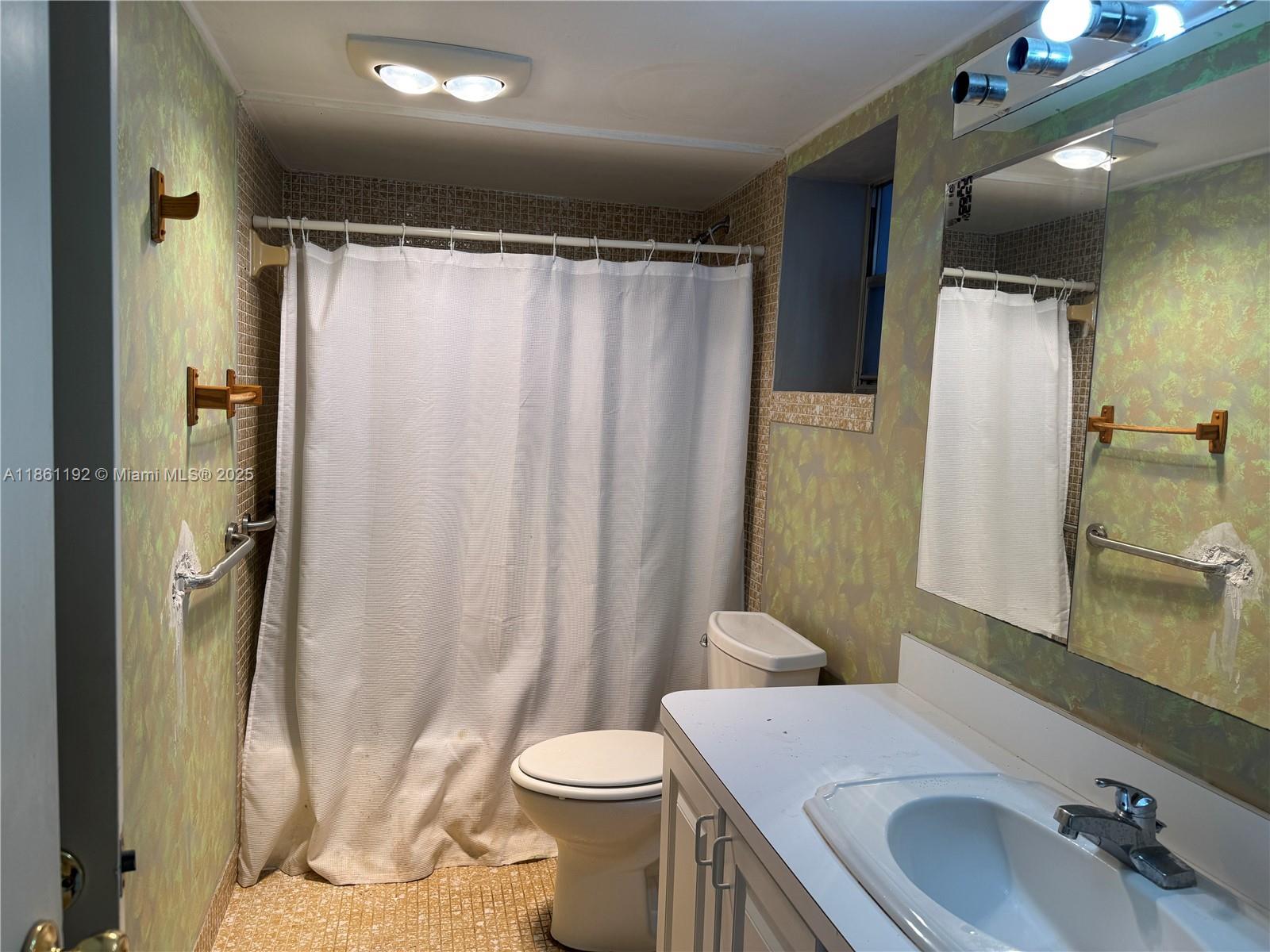 3090 Holiday Springs Boulevard, Unit 206 Margate, FL 33063 - Photo 33 of 41 a bathroom with a sink toilet and shower