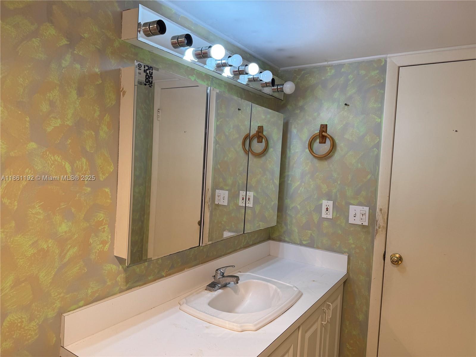 3090 Holiday Springs Boulevard, Unit 206 Margate, FL 33063 - Photo 35 of 41 a bathroom with a sink vanity mirror and shower