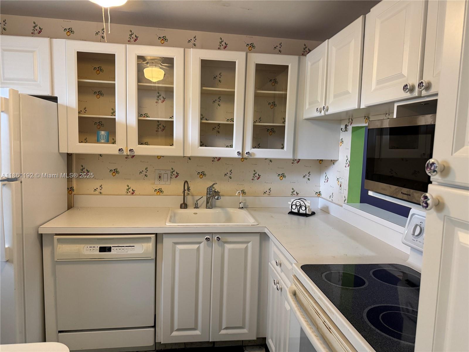 3090 Holiday Springs Boulevard, Unit 206 Margate, FL 33063 - Photo 36 of 41 a kitchen with stainless steel appliances a stove a sink and a microwave