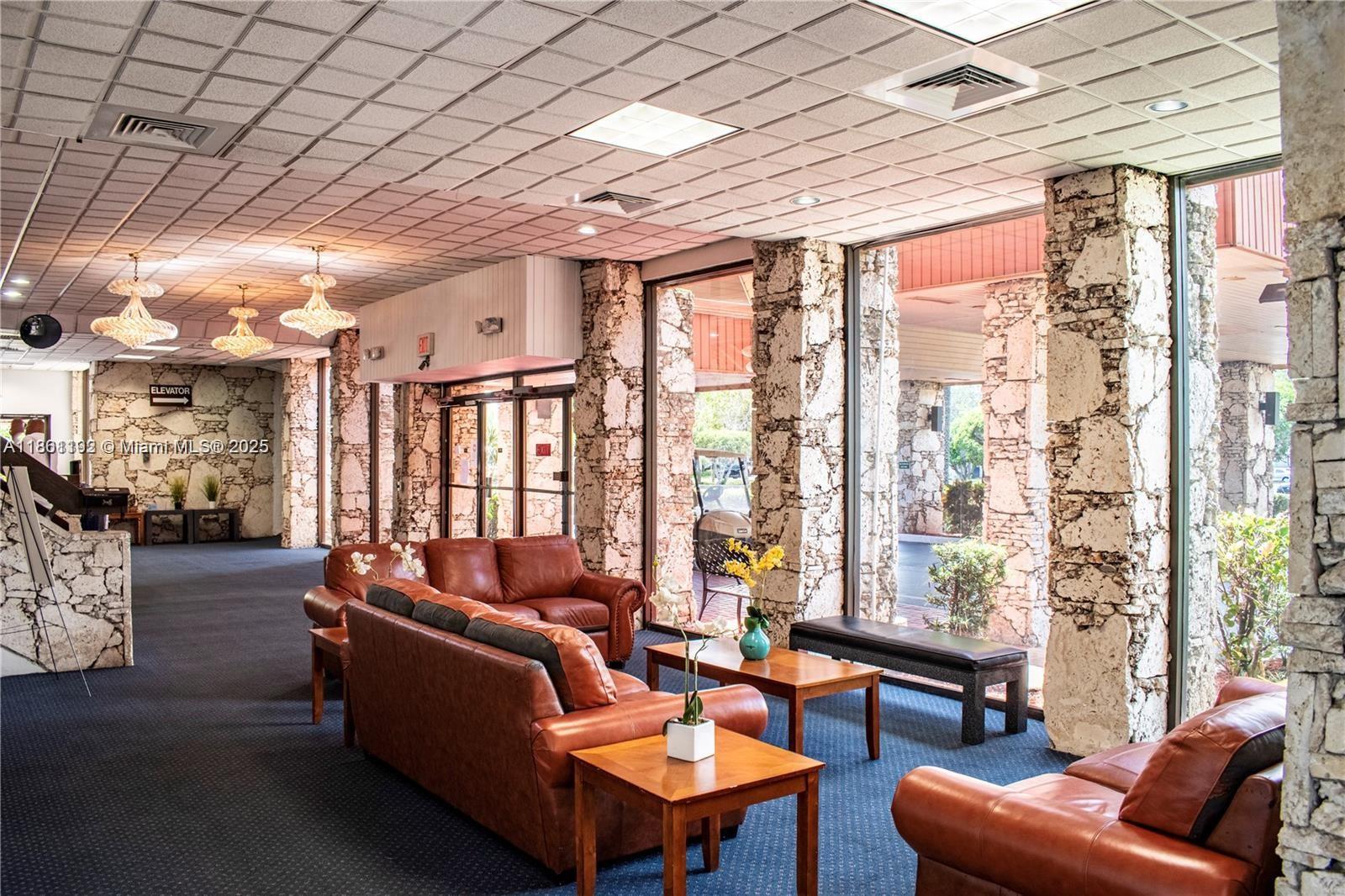 3090 Holiday Springs Boulevard, Unit 206 Margate, FL 33063 - Photo 4 of 41 a living room with furniture and a large window