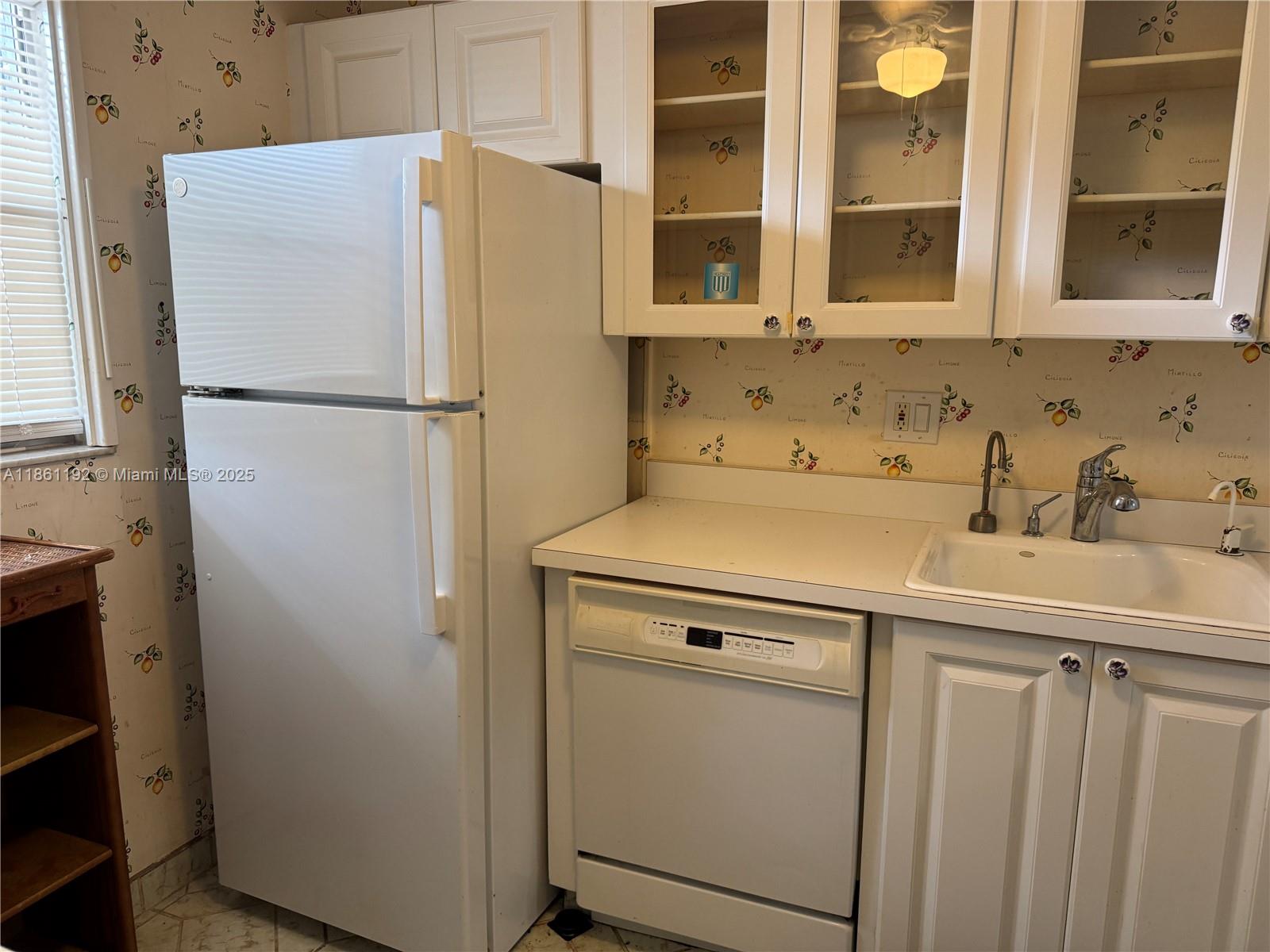 3090 Holiday Springs Boulevard, Unit 206 Margate, FL 33063 - Photo 41 of 41 a white refrigerator freezer sitting inside of a kitchen