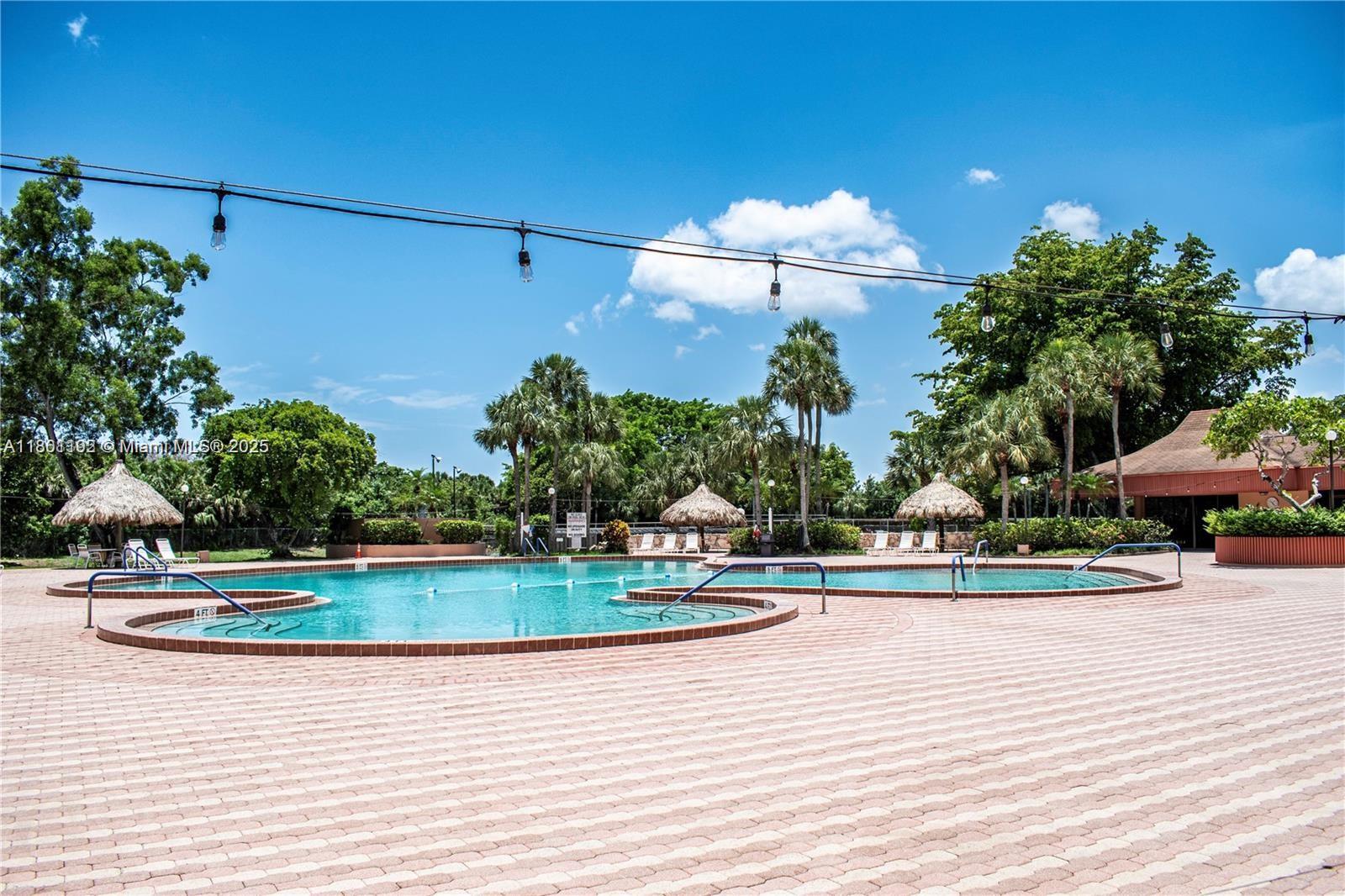 3090 Holiday Springs Boulevard, Unit 206 Margate, FL 33063 - Photo 5 of 41 a view of a swimming pool and lounge chair