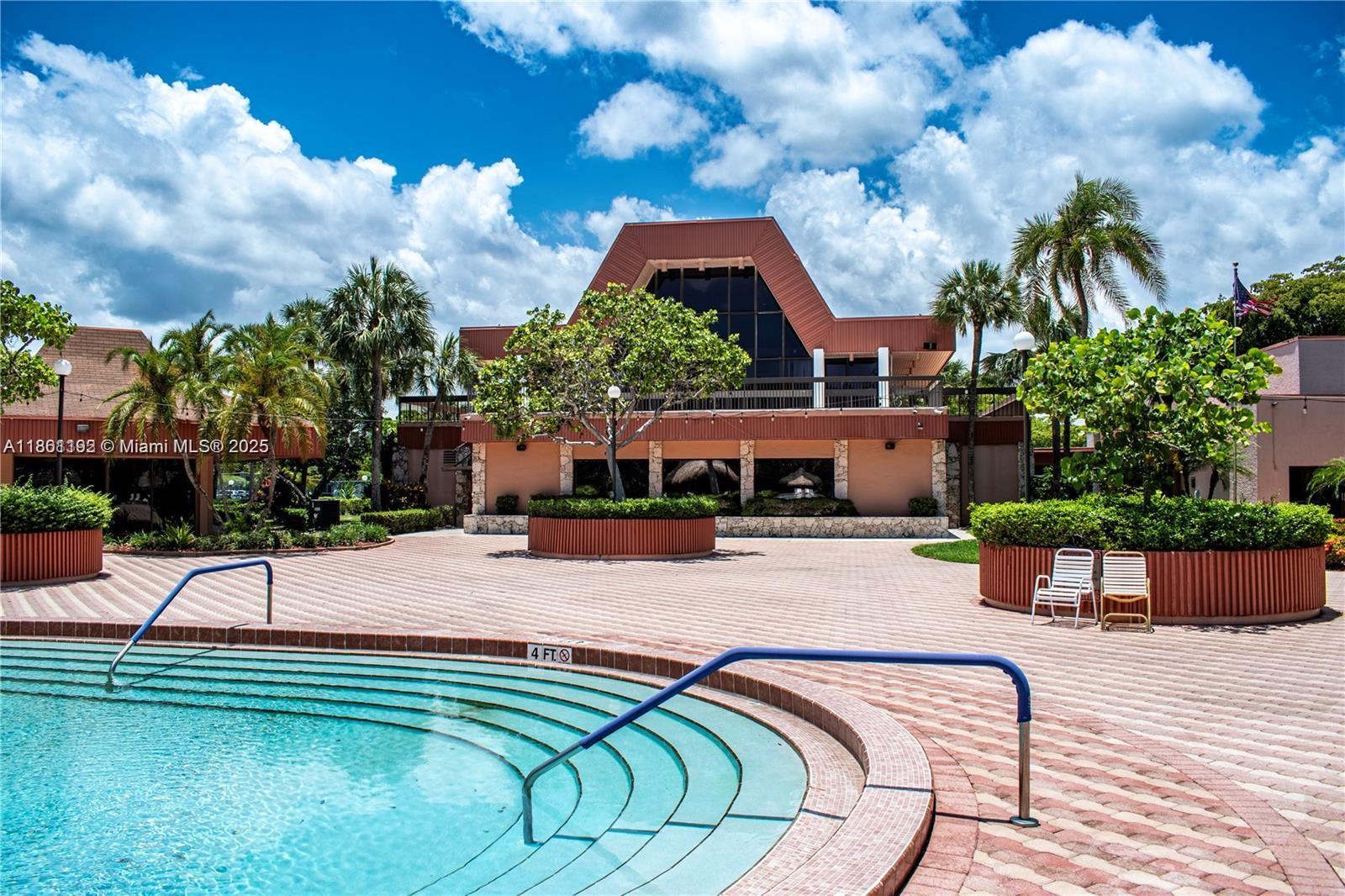3090 Holiday Springs Boulevard, Unit 206 Margate, FL 33063 - Photo 6 of 41 a swimming pool with outdoor seating