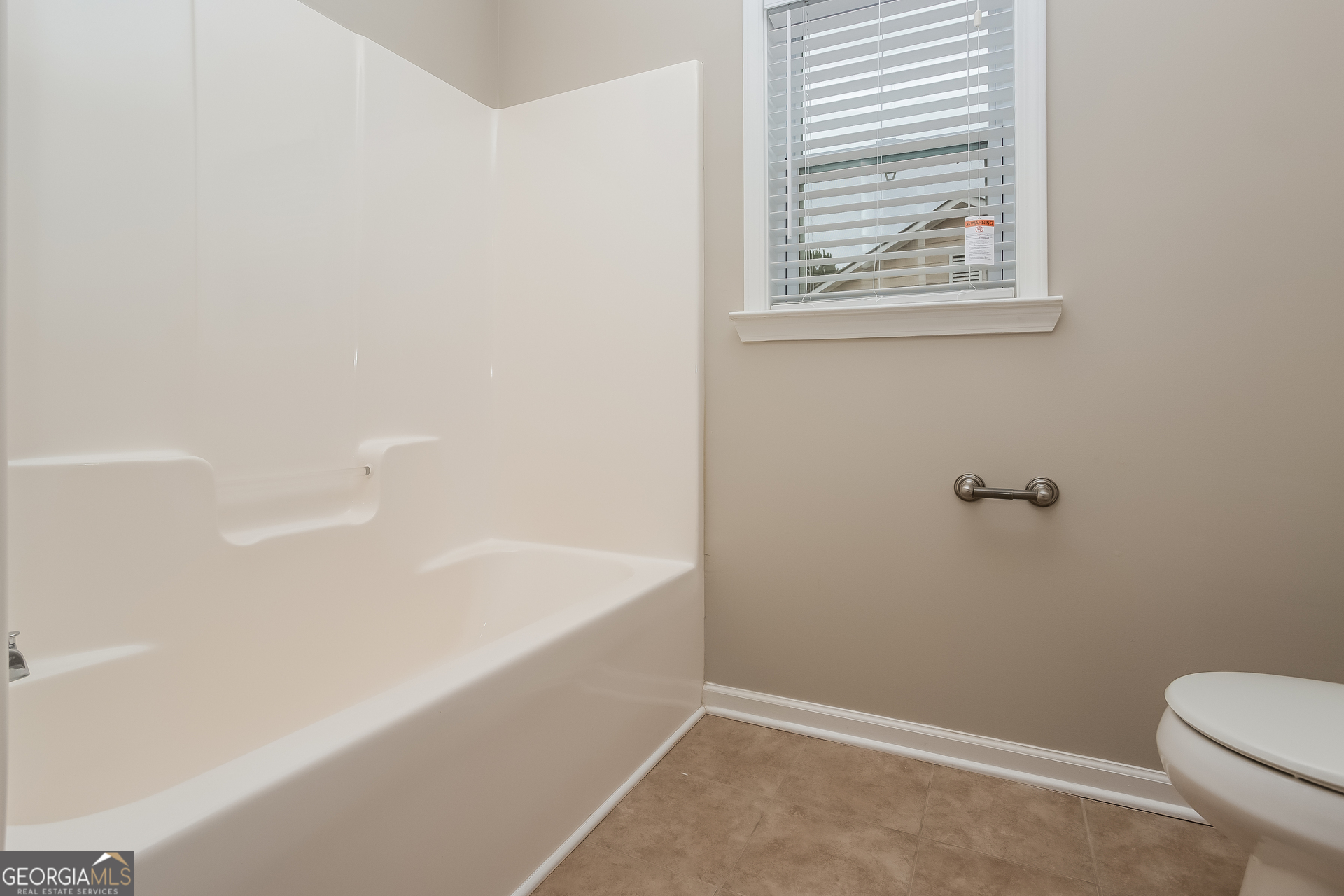 7159 Flagstone Place Union City, GA 30291 - Photo 13 of 15 a bathroom with a bathtub and window
