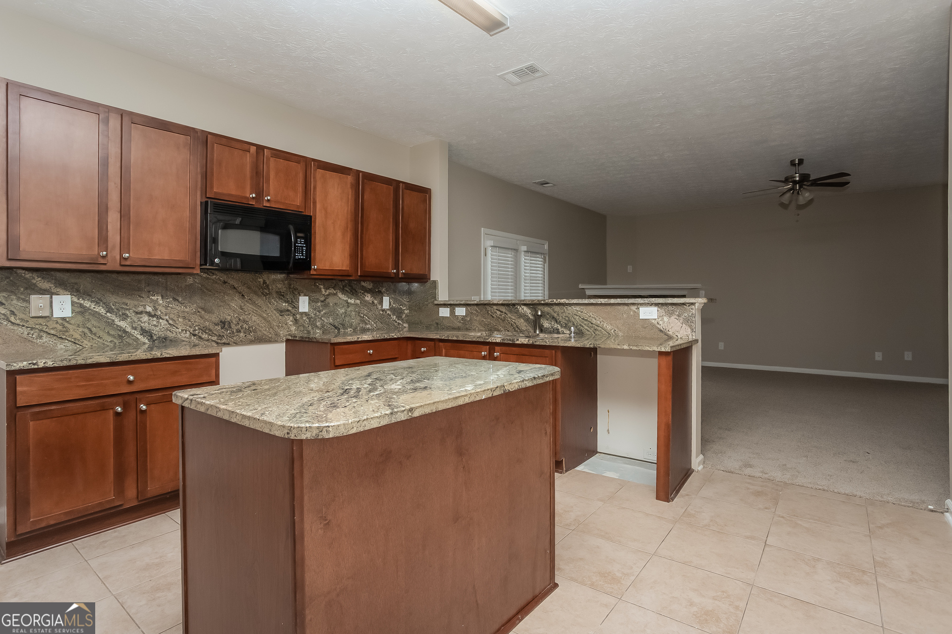 7159 Flagstone Place Union City, GA 30291 - Photo 6 of 15 a kitchen with stainless steel appliances granite countertop a sink stove and microwave