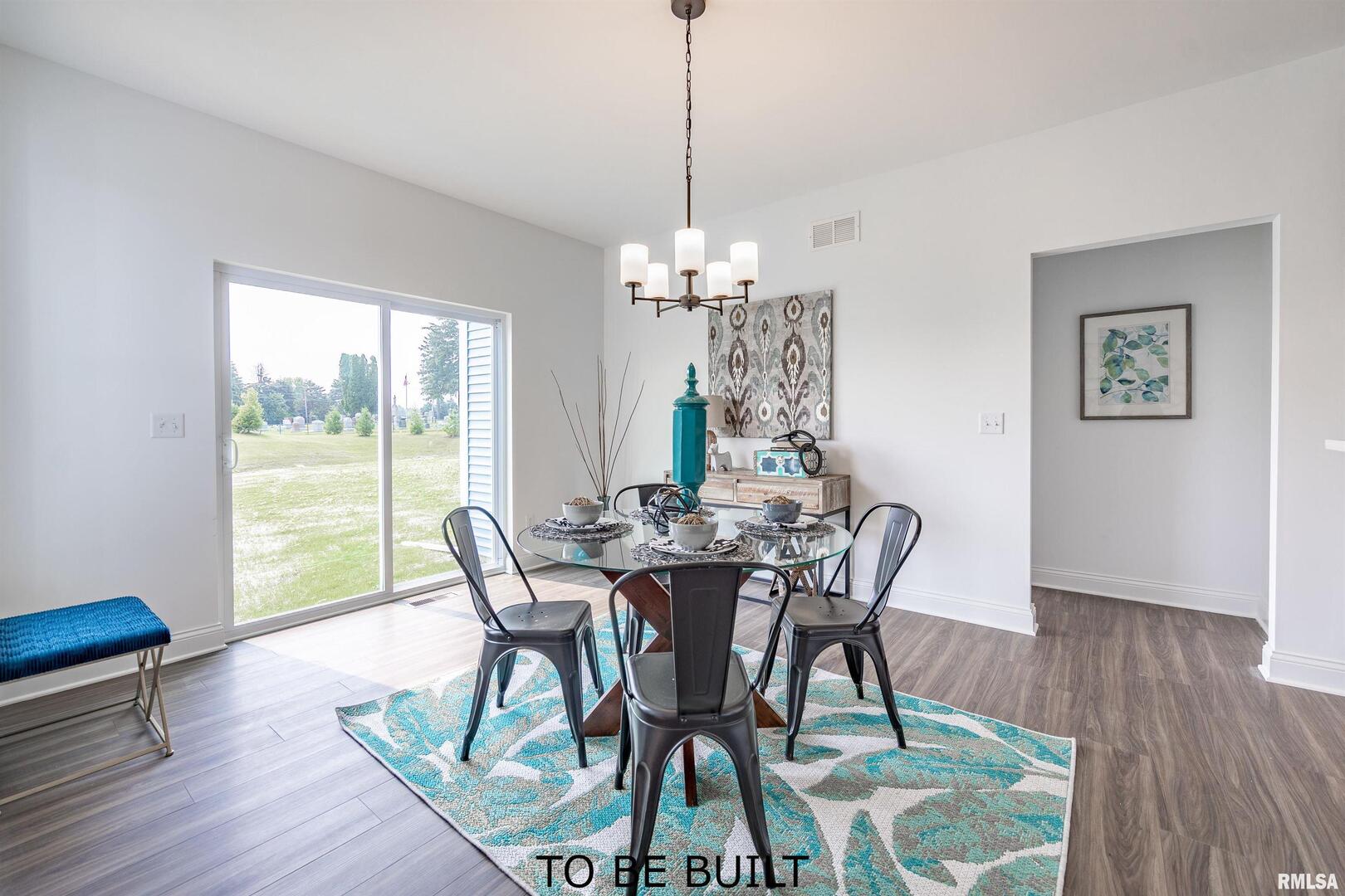 10 South 5th Street Eldridge, IA 52748 - Photo 5 of 29 a view of a dining room with furniture window and wooden floor