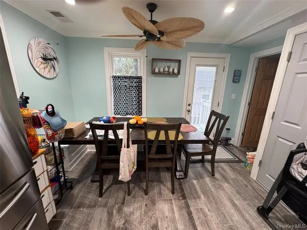 a view of a dining room with furniture and a chandelier