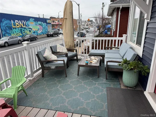a view of a balcony with chairs and a potted plant