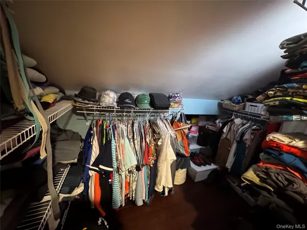 a view of walk in closet with clothes