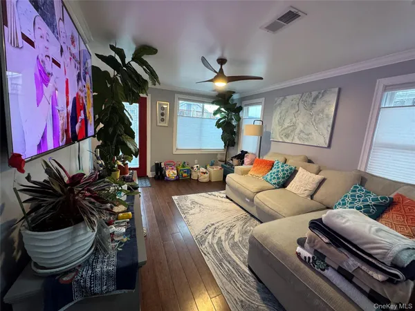 a living room with furniture and a chandelier