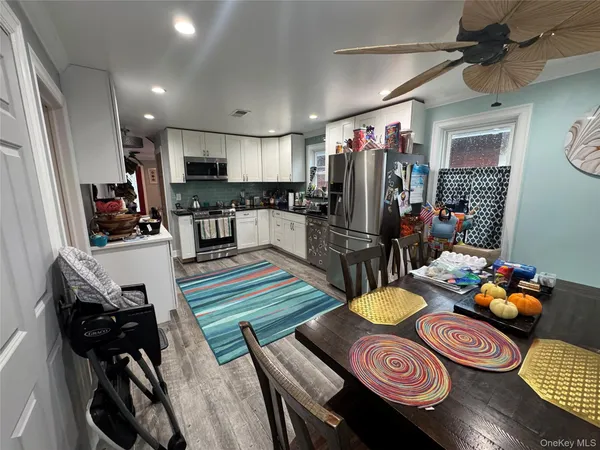 a view of a dining room with furniture and kitchen view
