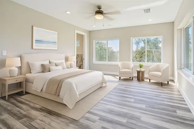 a spacious bedroom with a bed and a couch