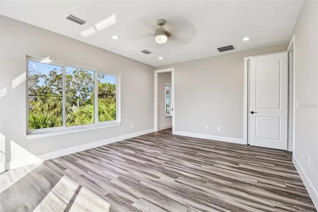 a view of a room with wooden floor and window