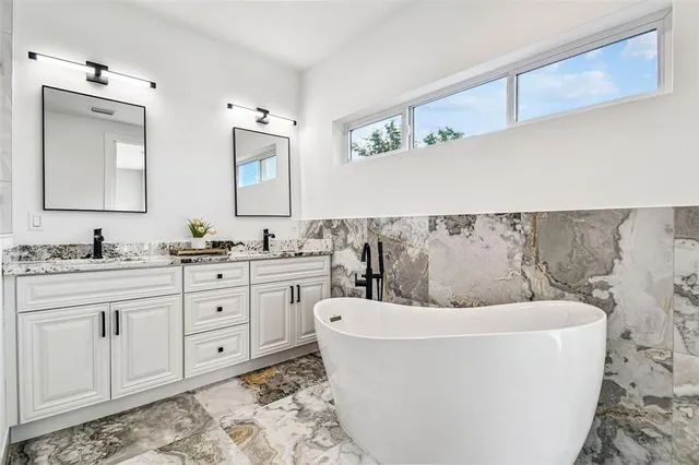 a bathroom with a bathtub and a sink