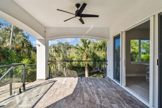 a view of a big room with wooden floor and windows