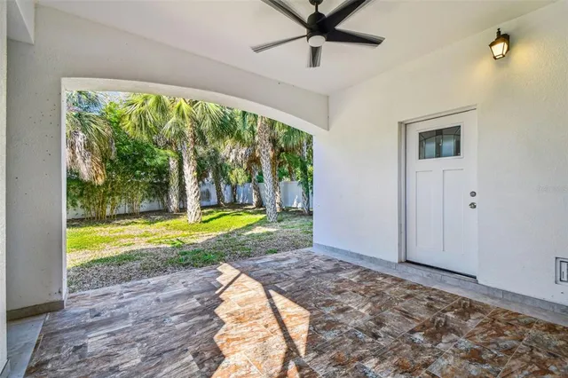 a view of a big room with wooden floor and windows