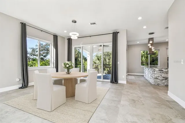 a large white kitchen with large windows