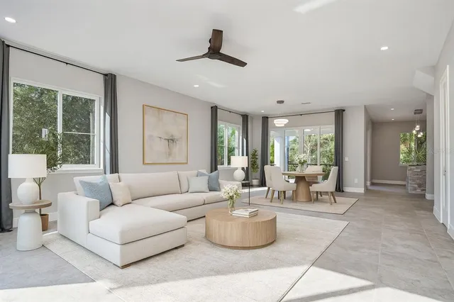 a living room with furniture and large windows