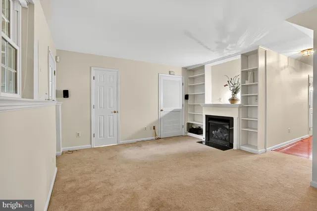 an empty room with furniture and a fireplace