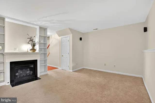 a view of empty room with a fireplace