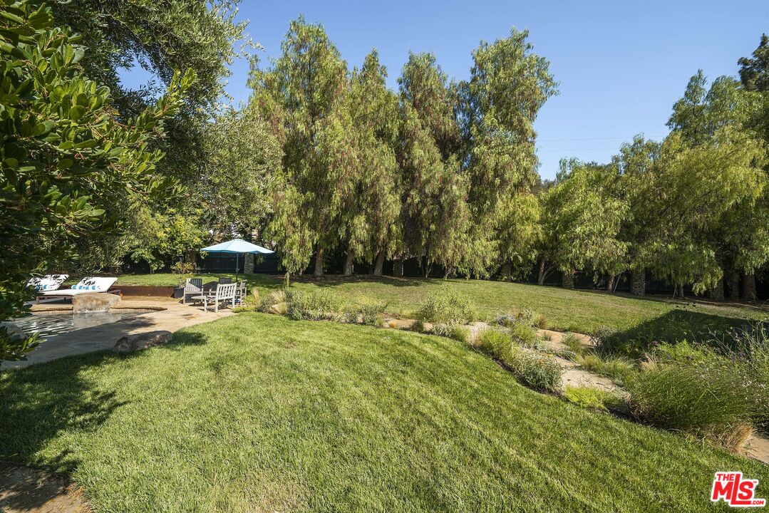 2251 Cold Canyon Road Calabasas, CA 91302 - Photo 43 of 47 a backyard of a house with trees and outdoor seating