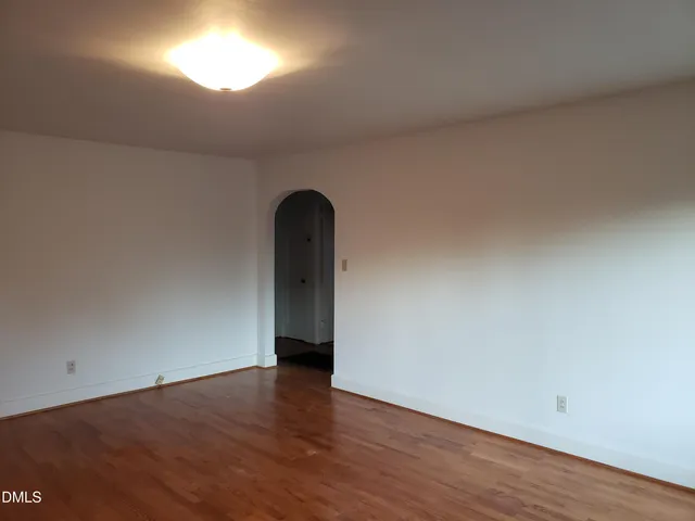 a view of an empty room and wooden floor