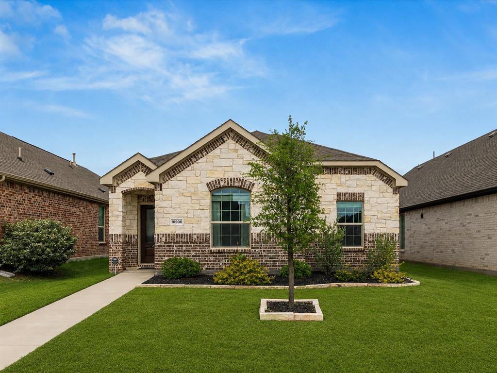 16936 Post Cedar Drive Justin, TX 76247 - Photo 1 of 30 Exterior facade featuring a combination of brick and stone masonry