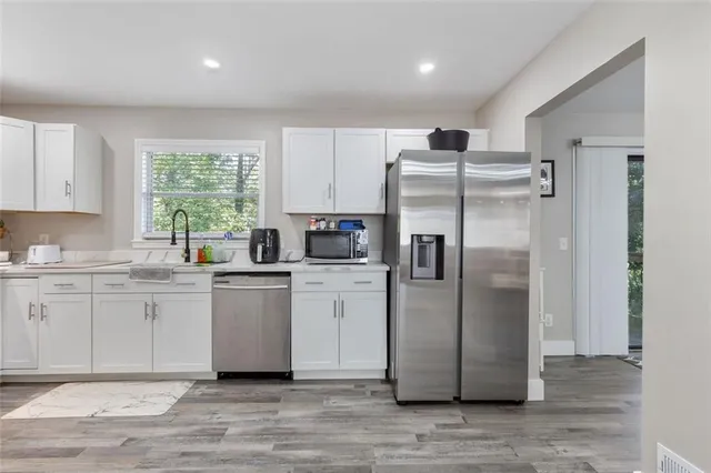 a kitchen with a refrigerator sink and microwave
