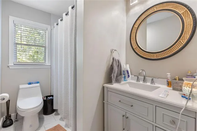 a bathroom with a sink a toilet and a mirror