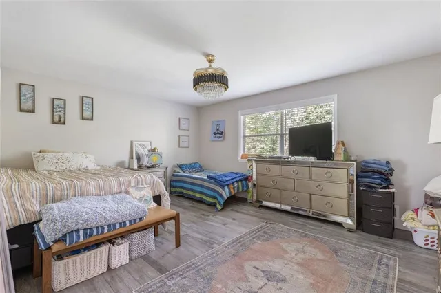 a bedroom with furniture and a flat screen tv