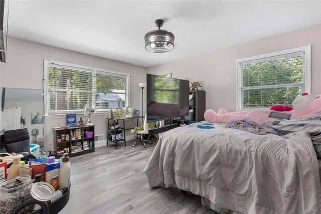 a bed room with a bed and a chair