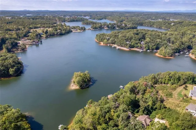 an aerial view of lake and residential houses with outdoor space