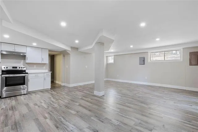 a view of kitchen with wooden floor and electronic appliances