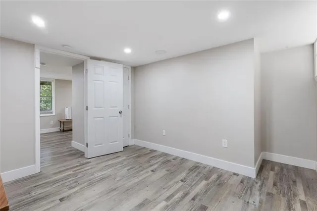 a view of a room with wooden floor and a sink