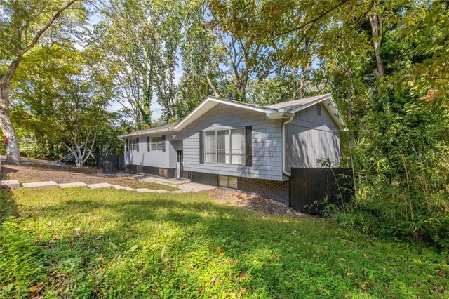 a front view of a house with swimming pool and porch