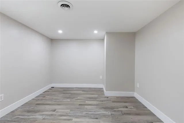 a view of room with wooden floor and fan