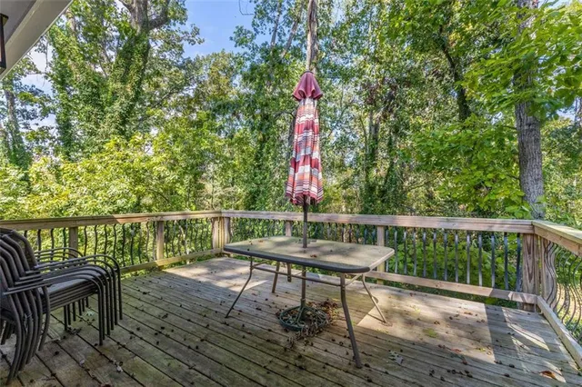 a view of a balcony with wooden floor and outdoor seating