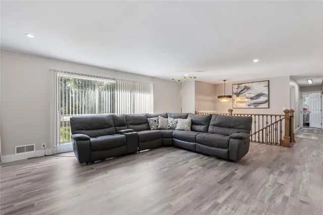 a living room with furniture and a wooden floor