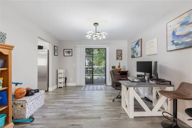 a workspace with wooden floor and a window