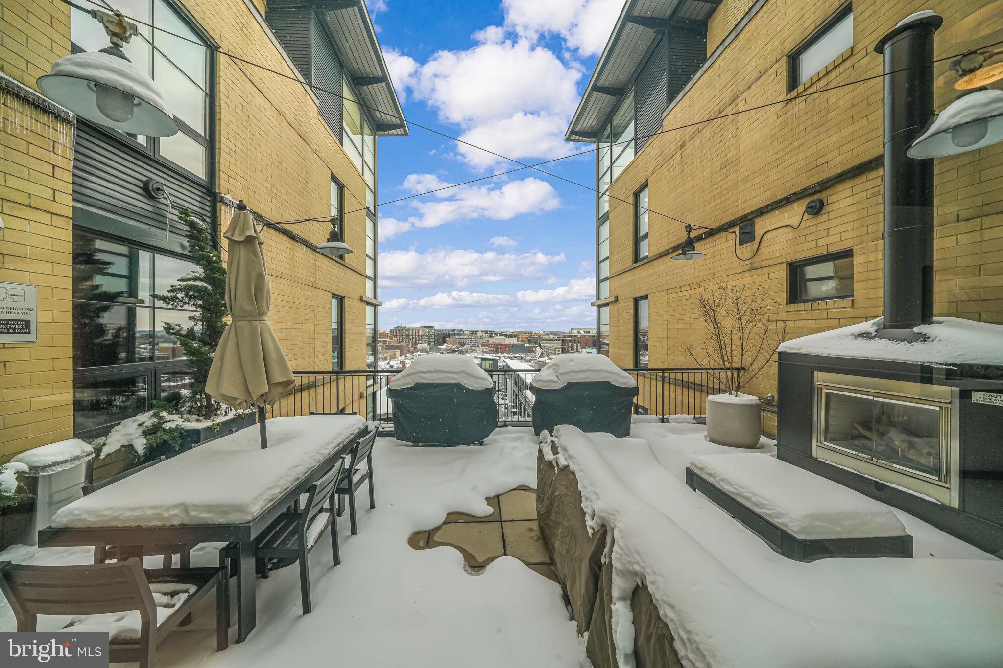 2125 14th Street Northwest, Unit 619 Washington, DC 20009 - Photo 8 of 22 a view of a terrace with furniture and a fireplace