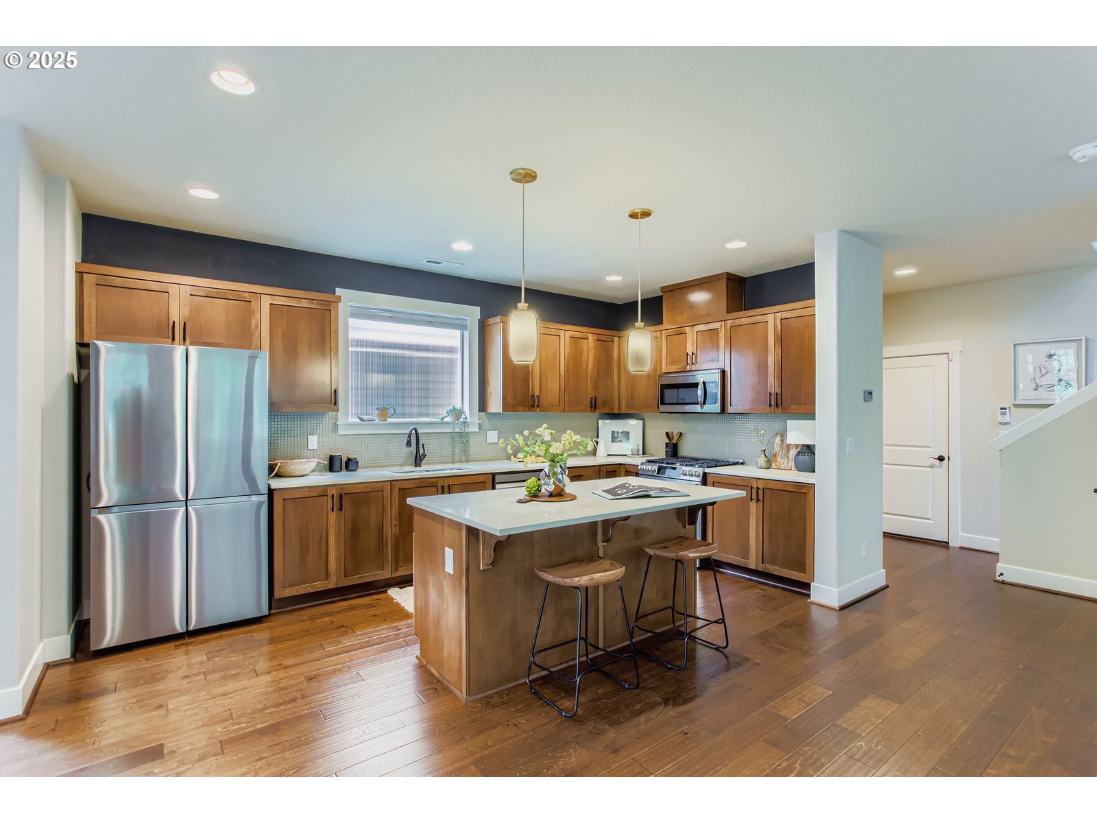 13575 Southwest Calabash Terrace Sherwood, OR 97140 - Photo 11 of 31 a kitchen with stainless steel appliances granite countertop a refrigerator a sink dishwasher a stove and a refrigerator with wooden floor