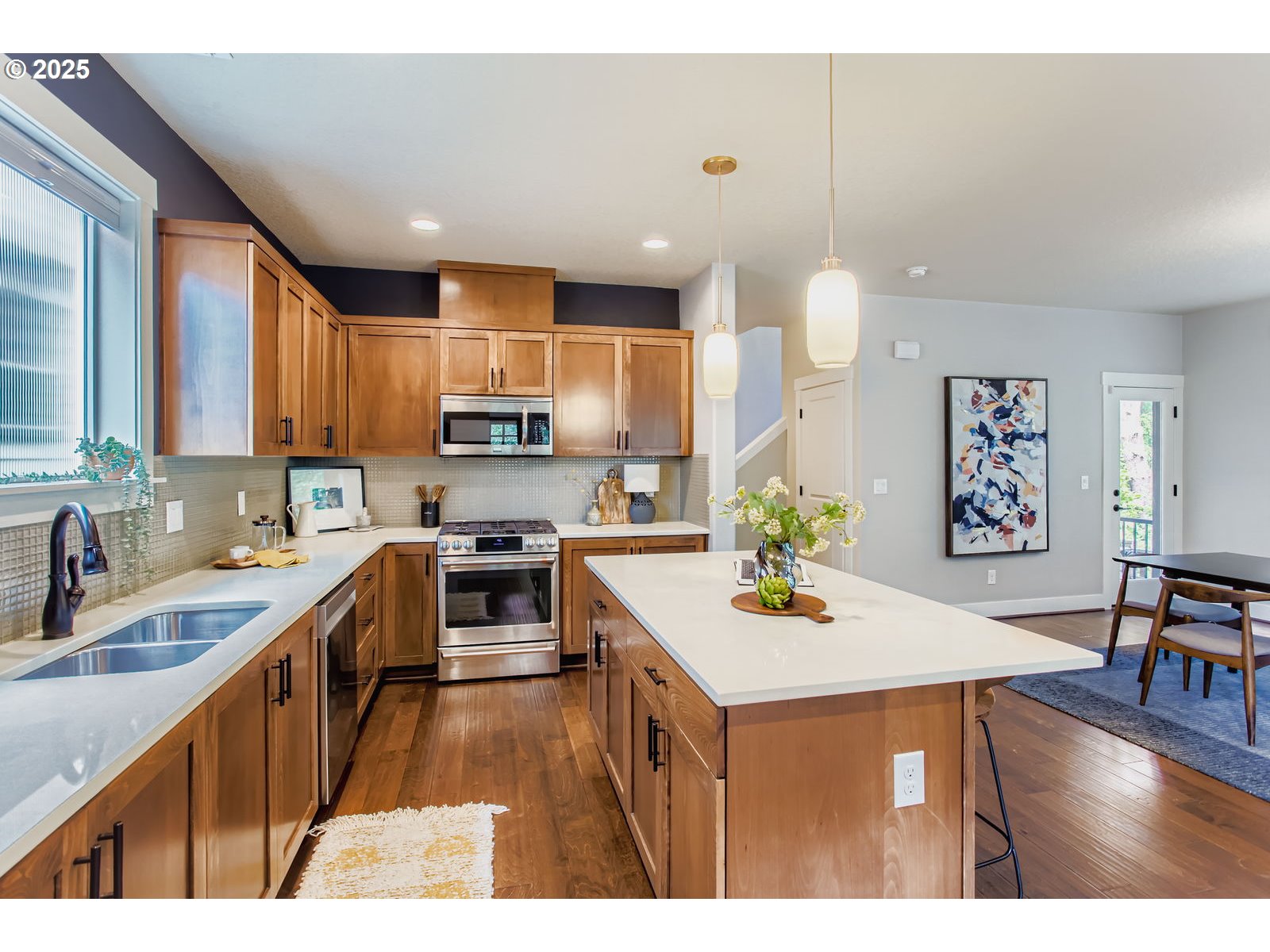 13575 Southwest Calabash Terrace Sherwood, OR 97140 - Photo 12 of 31 a kitchen with kitchen island granite countertop wooden cabinets a stove a sink and a center island