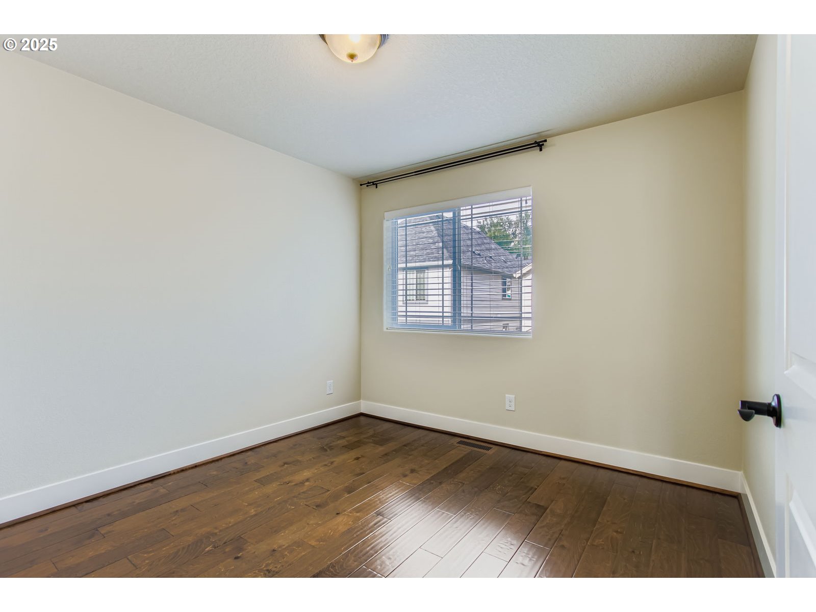 13575 Southwest Calabash Terrace Sherwood, OR 97140 - Photo 21 of 31 an empty room with wooden floor and windows