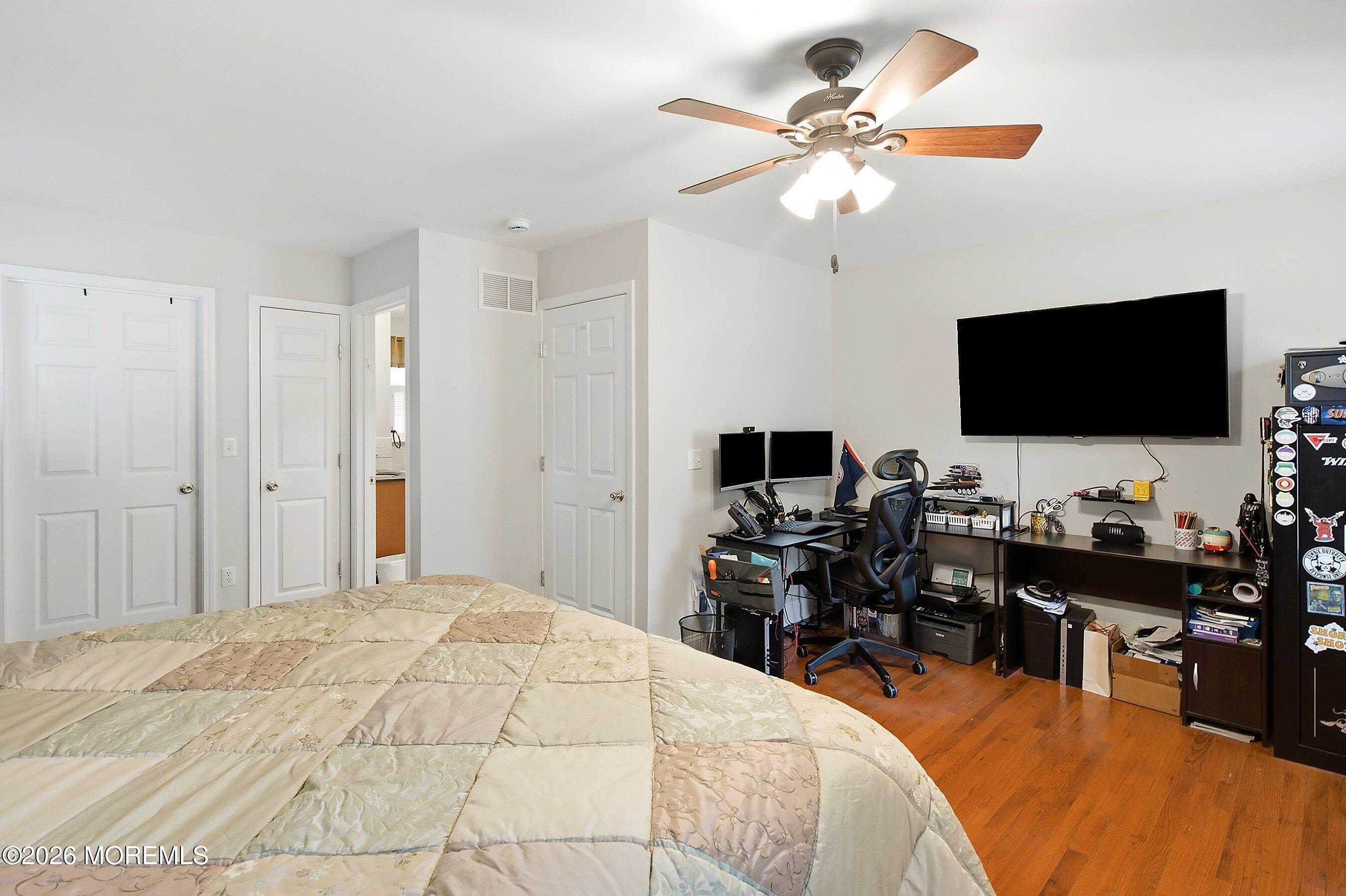 935 Bethel Church Road Jackson, NJ 08527 - Photo 14 of 32 a bedroom with a bed and a flat screen tv