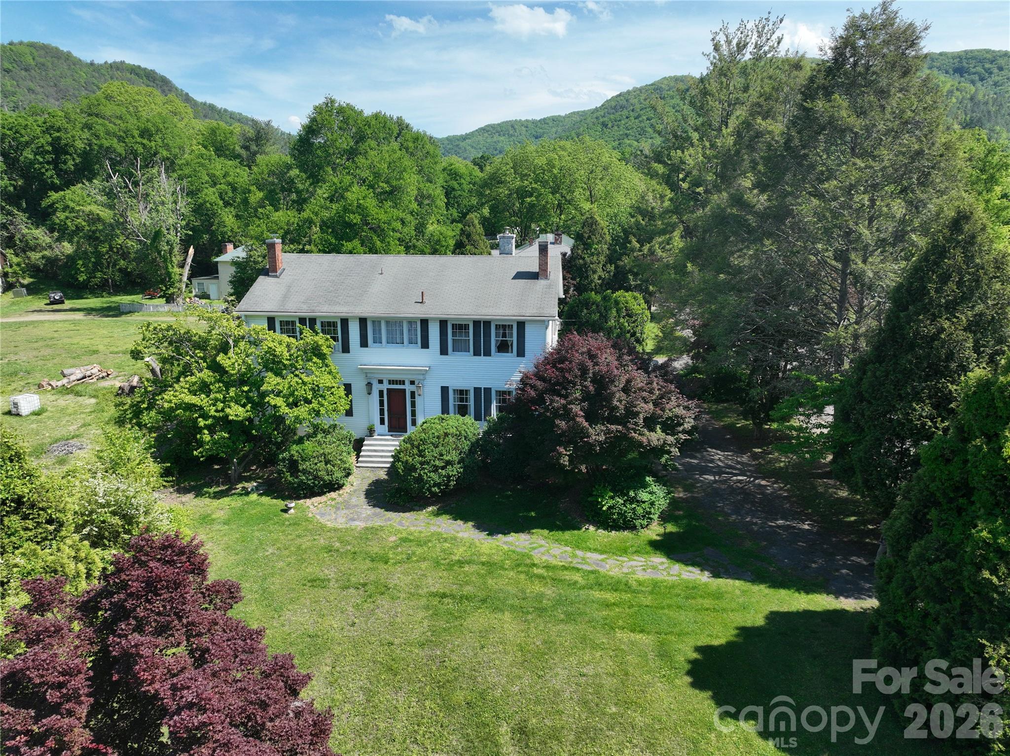 29 Walnut Street Hot Springs, NC 28743 - Photo 1 of 46 a view of a garden with a building in the background